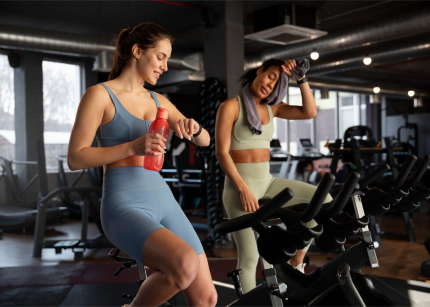 Две девушки закончили кардио тренировку на велотренажере